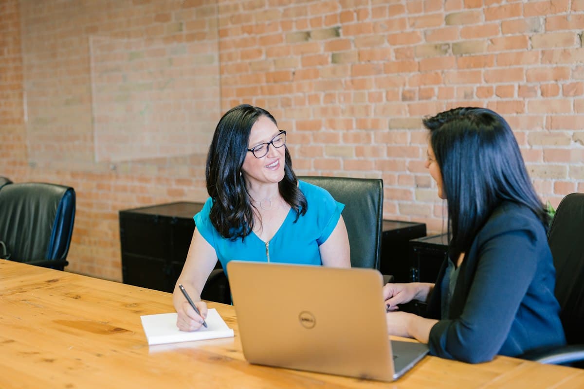 Two people having a friendly consultation over a laptop